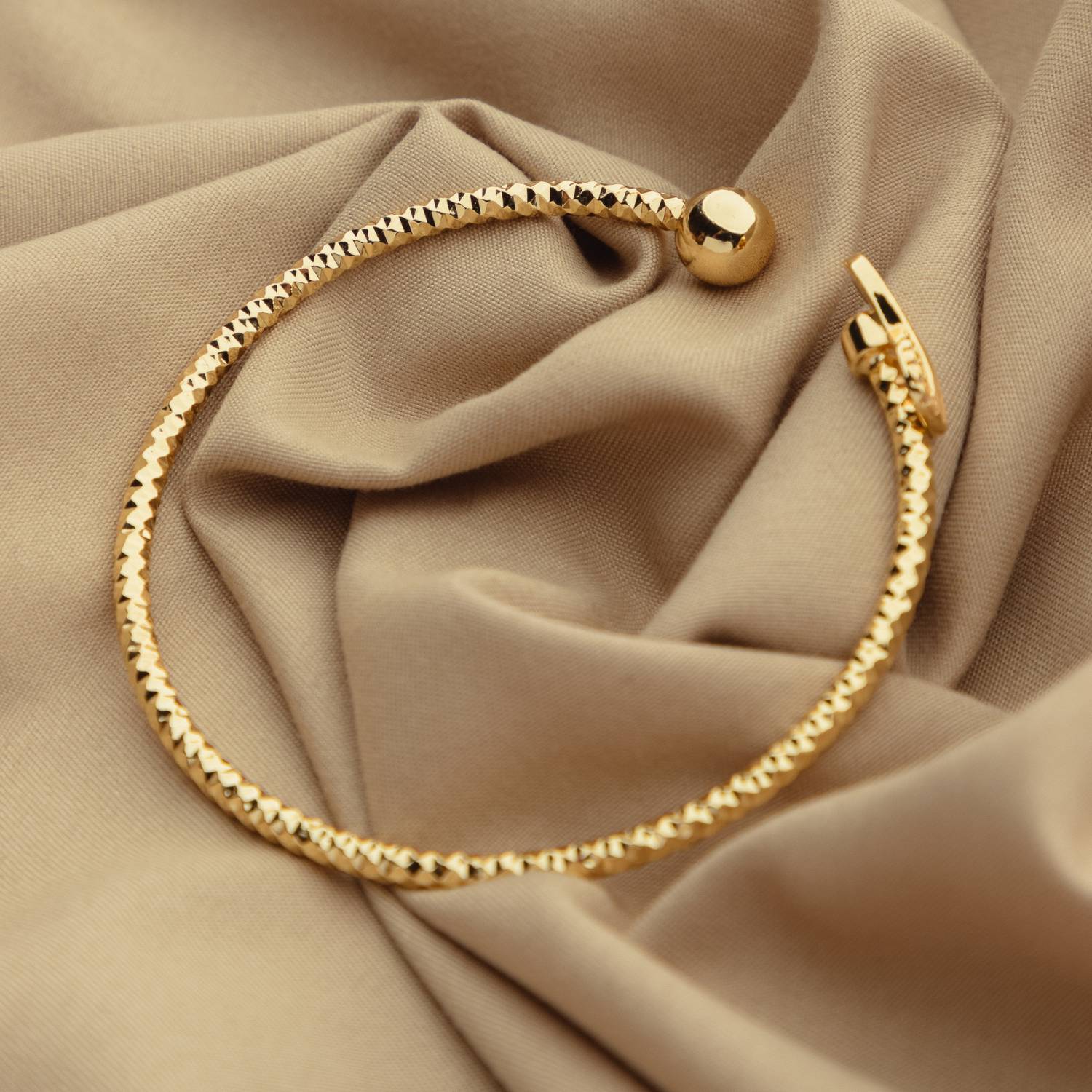 A bangle bracelet on fabric