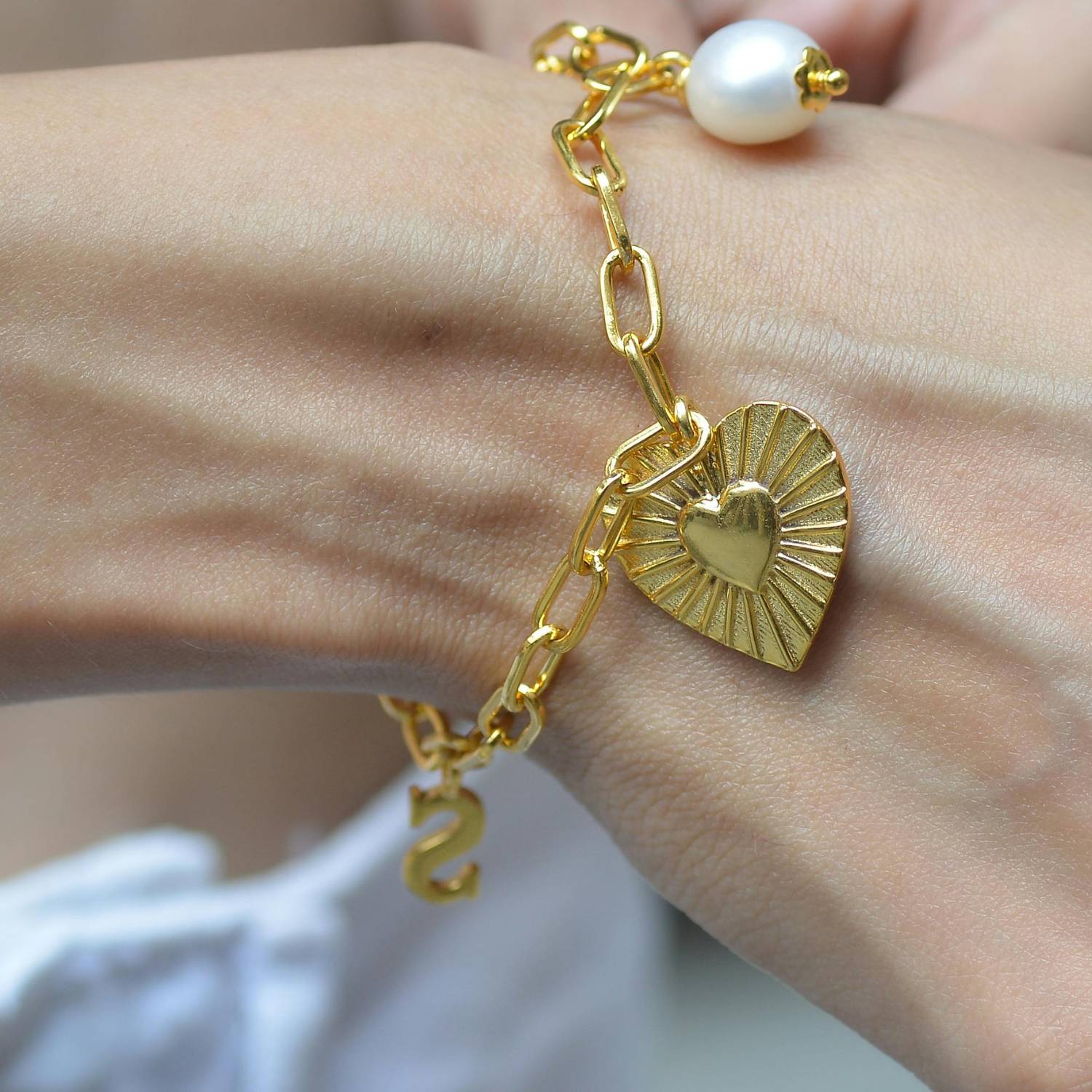 A charm bracelet with a heart charm